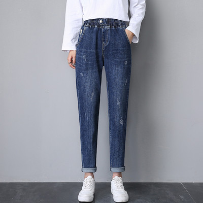 Női széles szárú farmer szakadt motívumokkal, gombos rögzítéssel