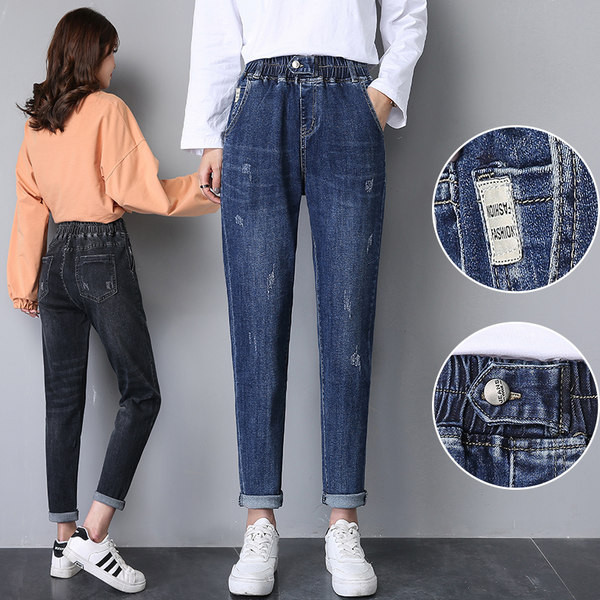 Női széles szárú farmer szakadt motívumokkal, gombos rögzítéssel