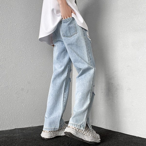 Dviejų spalvų vyriški džinsai su kirptais motyvais