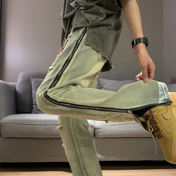 Modern férfi farmer, oldalsó cipzárral, szakadt motívumokkal