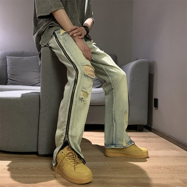 Modern férfi farmer, oldalsó cipzárral, szakadt motívumokkal