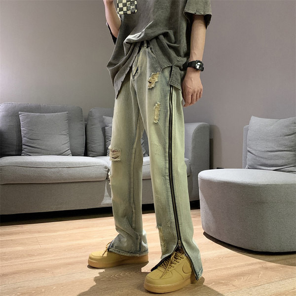 Modern férfi farmer, oldalsó cipzárral, szakadt motívumokkal