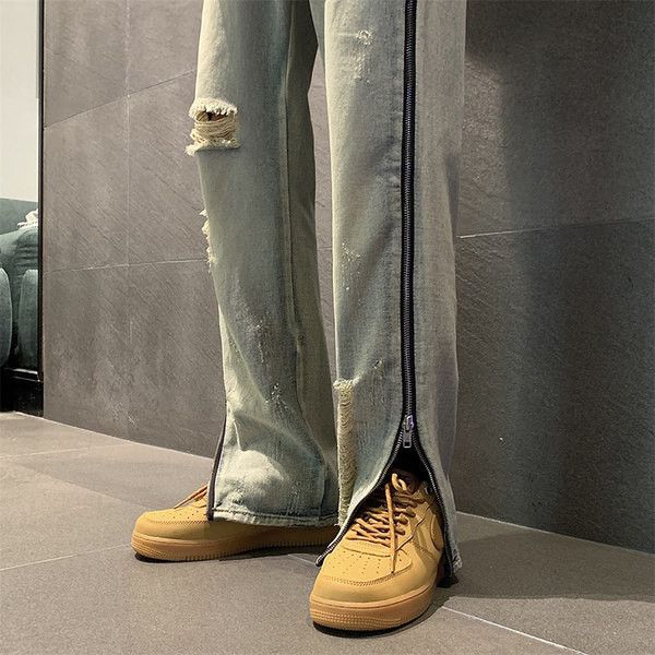 Modern férfi farmer, oldalsó cipzárral, szakadt motívumokkal