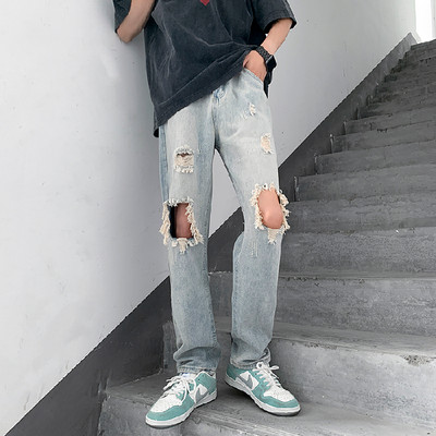 Meeste sirge säärega teksapüksid, millel on rebitud motiivid ja tasku