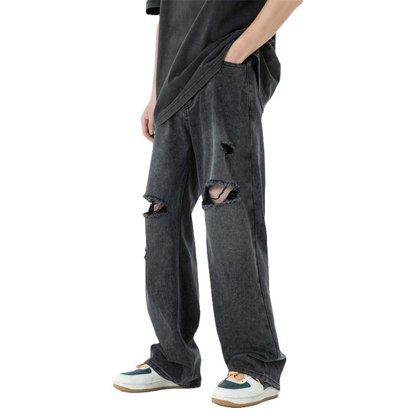 Széles szárú férfi farmernadrág szakadt motívumokkal és zsebbel