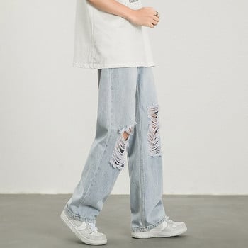 Φαρδύ τζιν παντελόνι με σκισμένα μοτίβα