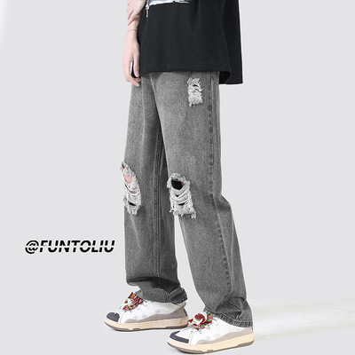 Ανδρικό τζιν με φαρδιά εφαρμογή με τσέπη και σκισμένα μοτίβα