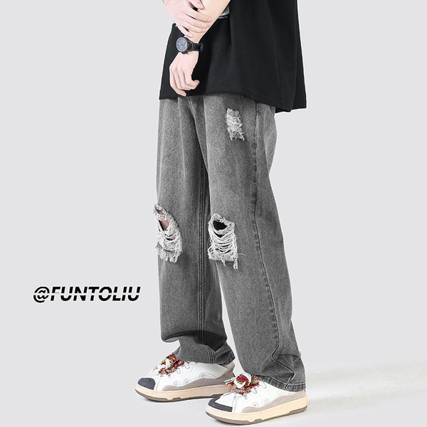 Ανδρικό τζιν με φαρδιά εφαρμογή με τσέπη και σκισμένα μοτίβα