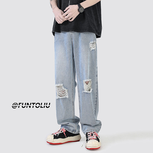 Ανδρικό τζιν με φαρδιά εφαρμογή με τσέπη και σκισμένα μοτίβα