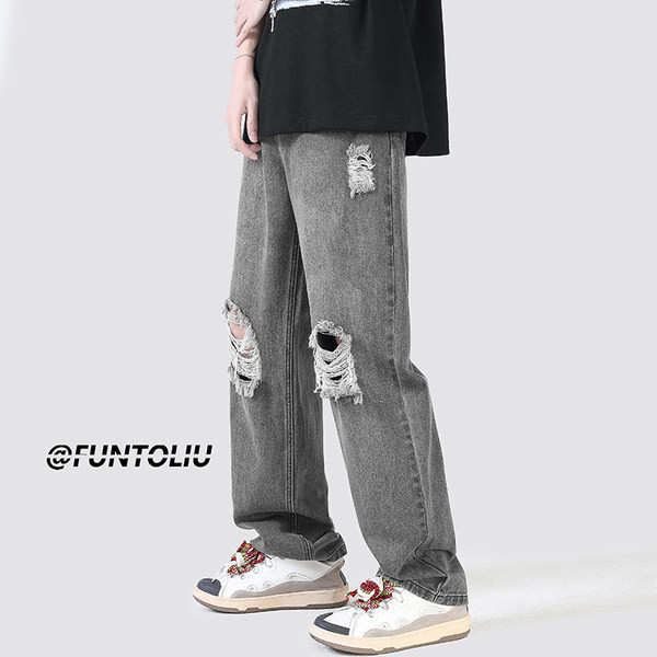 Ανδρικό τζιν με φαρδιά εφαρμογή με τσέπη και σκισμένα μοτίβα