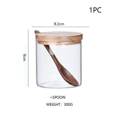 Staklena posuda za začine s drvenim poklopcem. Staklo za pohranu hrane. Prozirni spremnici. Kuhinjski šank. Zatvoreni spremnik. Sol. Šećer. Rezerva začina. Alati