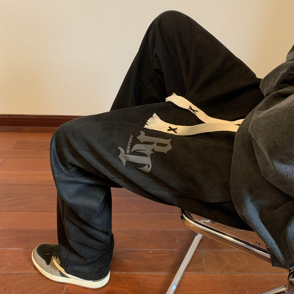 Pánske nohavice voľného strihu so šnúrkami a nápisom