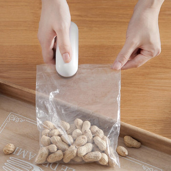 Μίνι στεγανοποιητικό μηχάνημα σνακ Πλαστική τσάντα χεριών πίεσης πλαστική φορητή Μικρή οικιακή σφράγιση συντήρησης τροφίμων