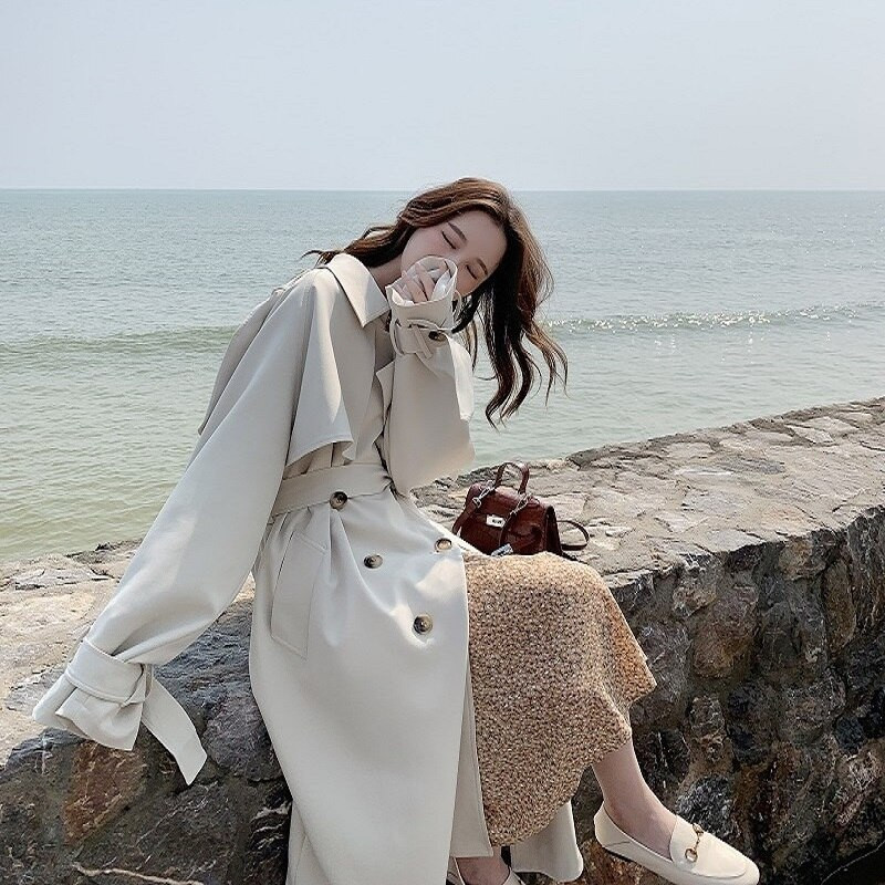 Augstas kvalitātes jostas vidēja garuma smilškrāsas Trench Jaka Sieviešu Ikdienas Retro Plats Atloks Garām Piedurknēm Vējjaka Sieviešu Rudens Jaunums